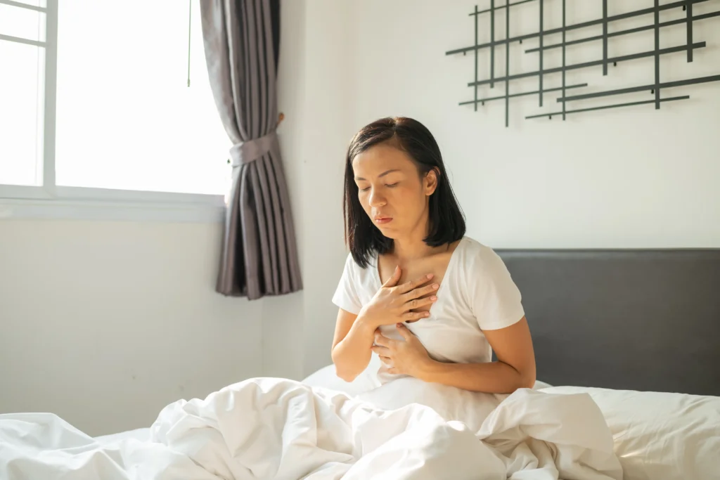 morning sickness young pregnant woman sitting bed covering her mouth feeling nauseous pregnancy woman white pajamas suffering from acid reflux while wake up her bed morning